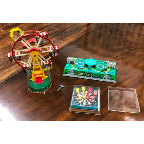 6151 - A tin plate key wind mechanical toy with miniature cars and buses on track, a tin plate Ferris wheel... 