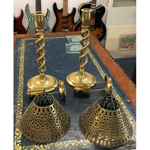 6186 - A pair of brass storm candlesticks with matching brass pierced shades.