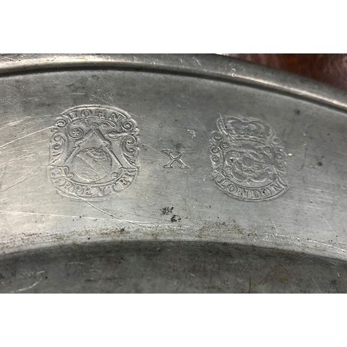 6181 - An early pewter charger, stamped John Carpenter London to back and inscribed to front, 38cm diameter... 