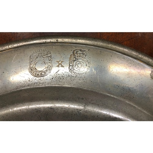 6181 - An early pewter charger, stamped John Carpenter London to back and inscribed to front, 38cm diameter... 