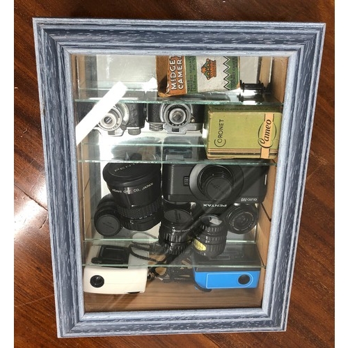 7105 - A small display cabinet containing 2 Coronet midget cameras, 2 micro cameras and a small Pentax Auto... 