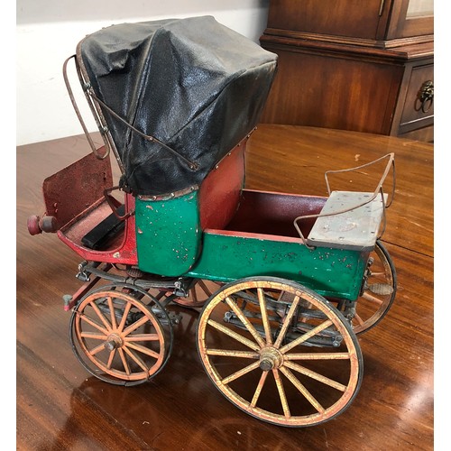 7103 - A  model tin horse carriage, 33cm high, 34cm wide.