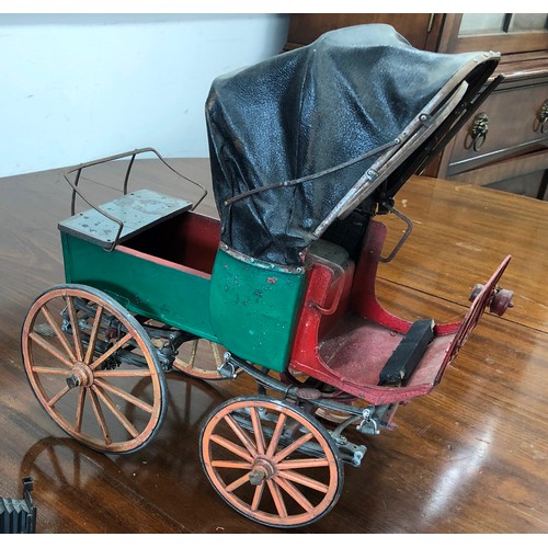 7103 - A  model tin horse carriage, 33cm high, 34cm wide.