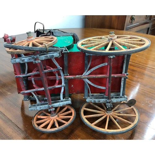 7103 - A  model tin horse carriage, 33cm high, 34cm wide.