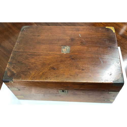 7091 - A wooden writing box with brass edge detail, hinged lid enclosing black leather writing slope, stora... 