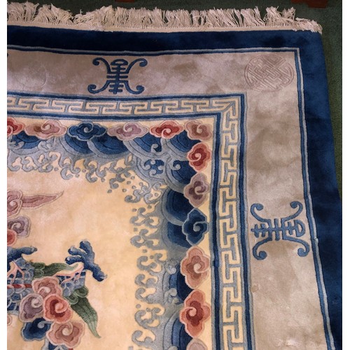 7084 - A large Oriental silk carpet on cream ground with blue, grey and pale green centre medallion and edg... 