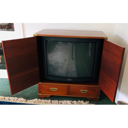 7078 - A reproduction campaign style TV cabinet with brass pull handles, 2 doors. (TV not included). (not h... 