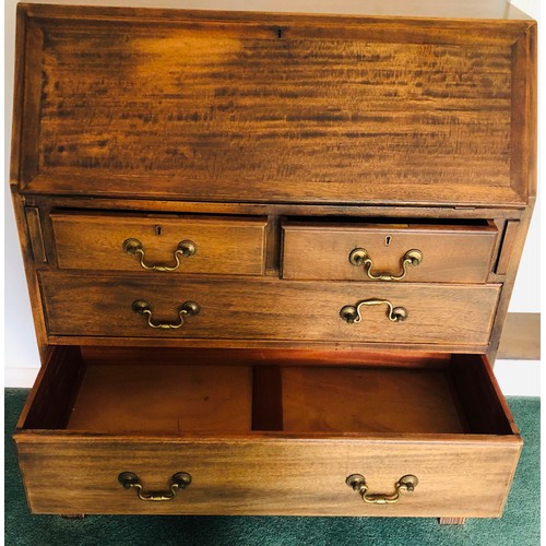 7075 - An oak bureau with fall front enclosing inner cubby holes, 2 short drawers, 2 long drawers with bras... 