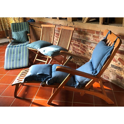 7069 - 2 teak steamer garden chairs, 2 teak folding chairs, a small teak folding oval table and various gar... 