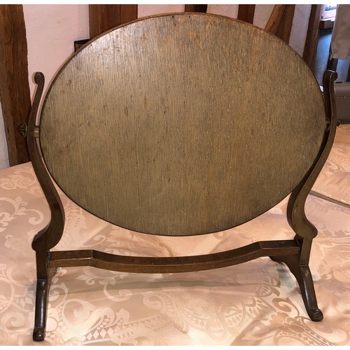 7067 - A small wood framed oval dressing table mirror with swivel fittings, 49.5cm high, 49cm wide. (not he... 