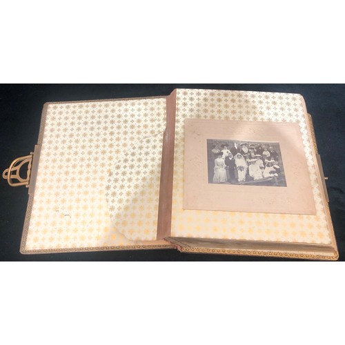 7046 - A leather bound photo album with clasp and a quantity of various different sized, black and white ph... 