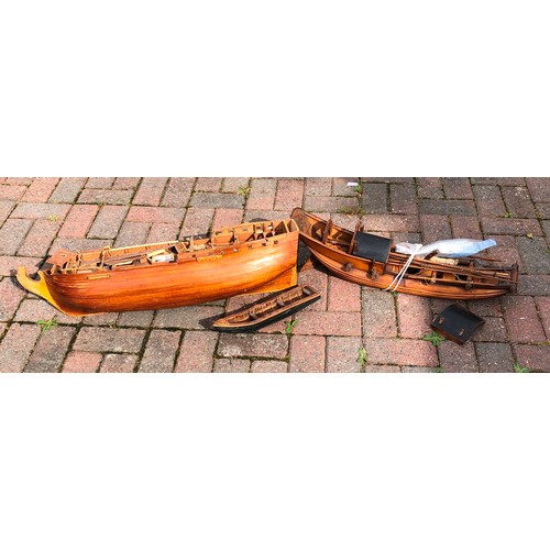 7124 - A wooden boat in the form of a junk, 68cm long and another wooden part galleon, 79cm long