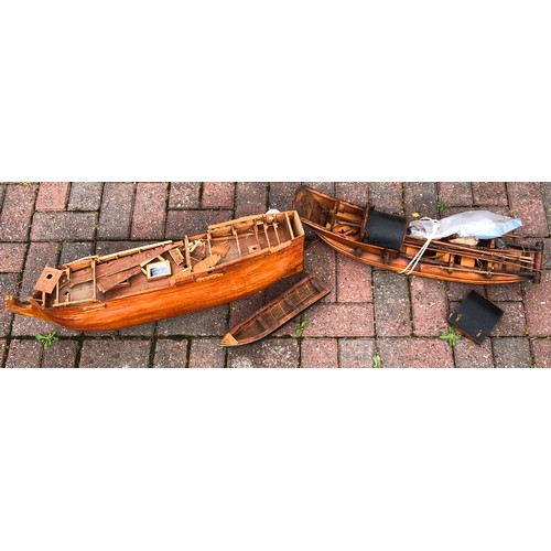 7124 - A wooden boat in the form of a junk, 68cm long and another wooden part galleon, 79cm long