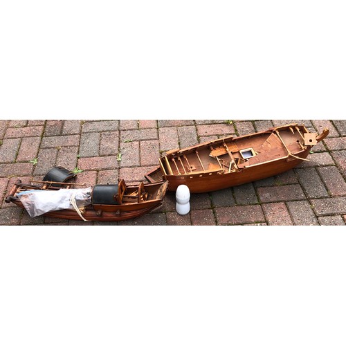 7124 - A wooden boat in the form of a junk, 68cm long and another wooden part galleon, 79cm long