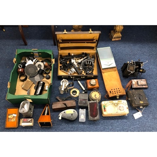 7142 - A quantity of photographic equipment, lenses, loose parts, a brown leather briefcase, a vintage Fren... 