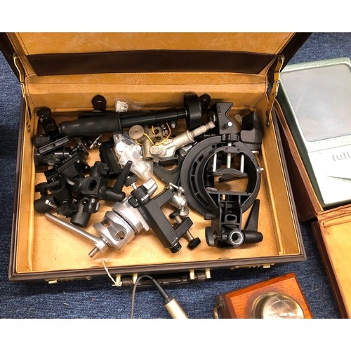 7142 - A quantity of photographic equipment, lenses, loose parts, a brown leather briefcase, a vintage Fren... 