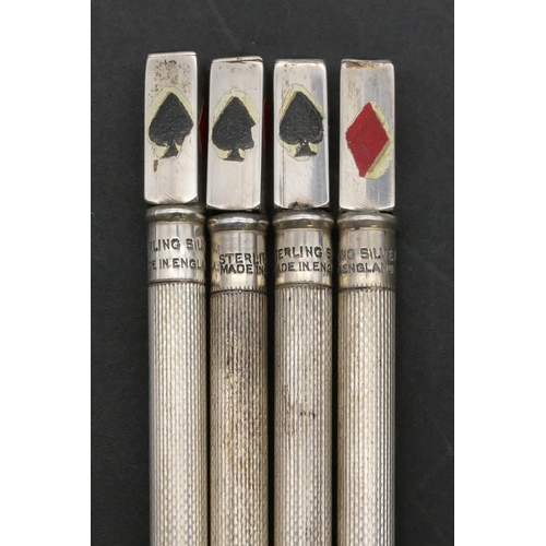 143 - A set of 4 Sterling silver bridge propelling pencils with enamelled club suites decoration in fitted... 