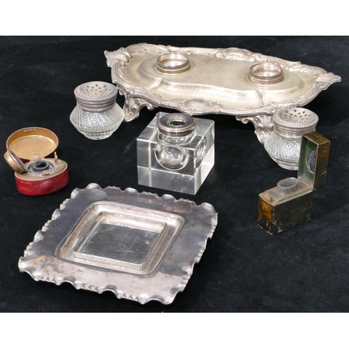 153 - A silver plated and glass inkwell with scallop shaped stand on splayed feet mounted with 2 glass bot... 