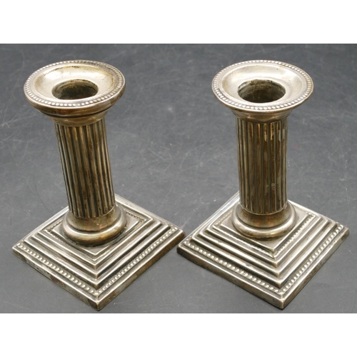 163 - A pair of Birmingham silver dwarf Corinthian column  candlesticks on sweeping bases, maker's mark W.... 