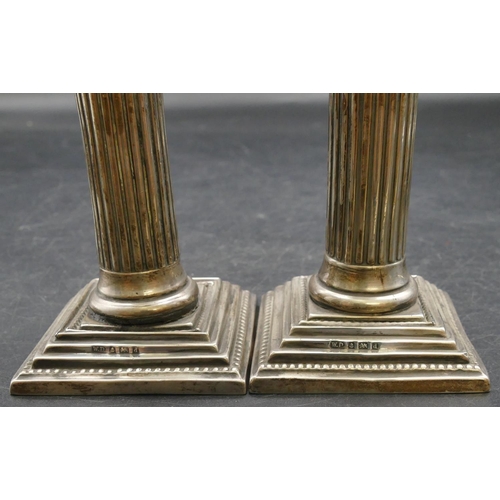 163 - A pair of Birmingham silver dwarf Corinthian column  candlesticks on sweeping bases, maker's mark W.... 