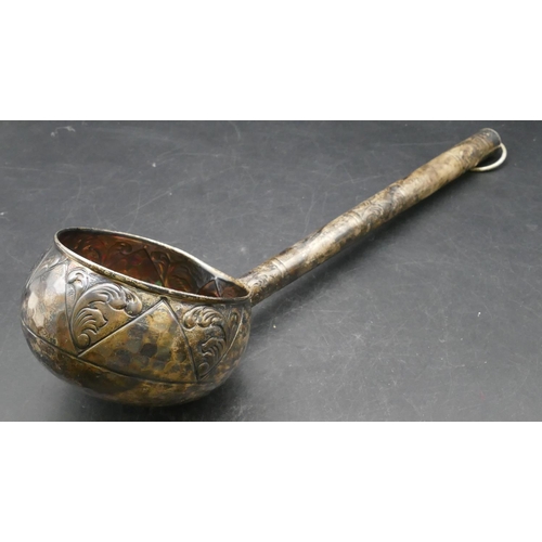 168 - An Eastern silver coloured metal ladle with part embossed leaf and scroll decoration, 47cm long, 6.6... 