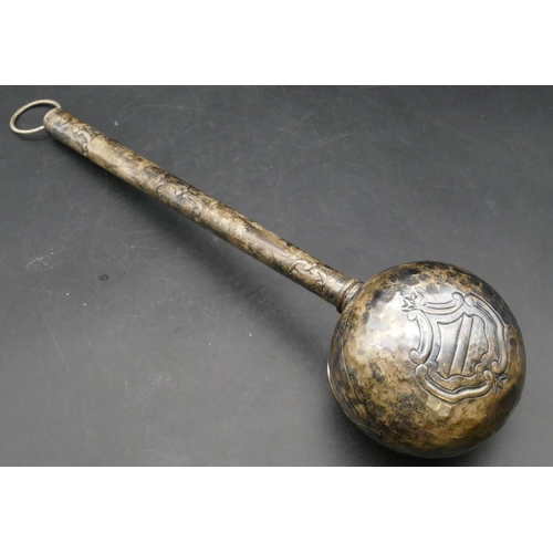 168 - An Eastern silver coloured metal ladle with part embossed leaf and scroll decoration, 47cm long, 6.6... 