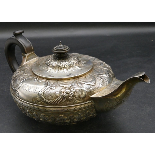 185 - A Victorian silver round bulbous shaped teapot with allover embossed swag, floral and leaf decoratio... 