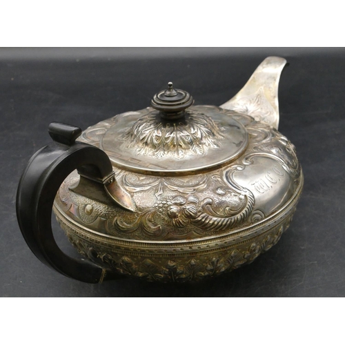 185 - A Victorian silver round bulbous shaped teapot with allover embossed swag, floral and leaf decoratio... 