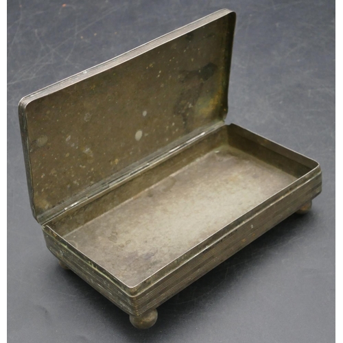 187 - A Continental silver coloured metal rectangular shaped box with hinged lid and engraved decoration o... 