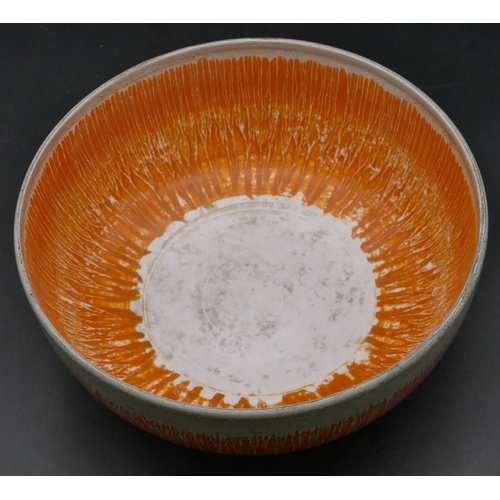 20 - A Shelley dripware round bulbous shaped fruit bowl on orange ground, 23.8cm diameter