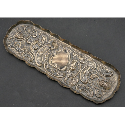 204 - A late Victorian oblong scallop shaped silver pin dish with embossed figurehead and scroll decoratio... 