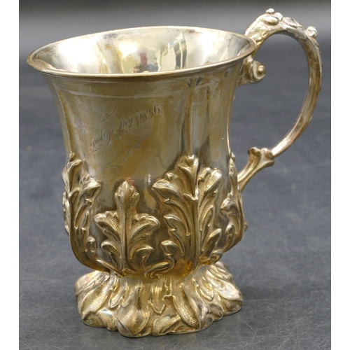 210 - A Walker & Hall Sheffield silver christening mug with raised leaf decoration and scroll handle, 5.3o... 