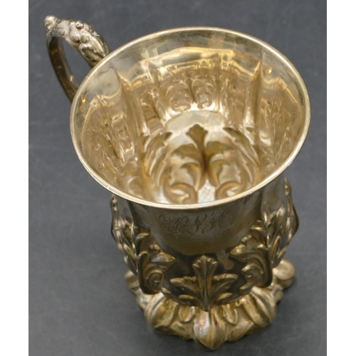 210 - A Walker & Hall Sheffield silver christening mug with raised leaf decoration and scroll handle, 5.3o... 