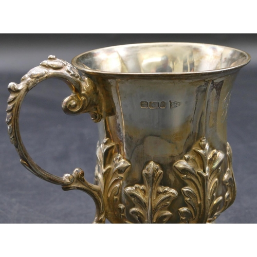 210 - A Walker & Hall Sheffield silver christening mug with raised leaf decoration and scroll handle, 5.3o... 