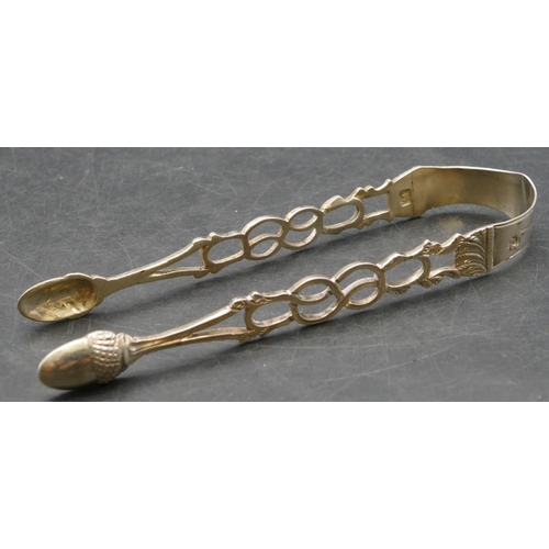 214 - A pair of Georgian silver sugar tongs with acorn shaped bowls with pierced arms