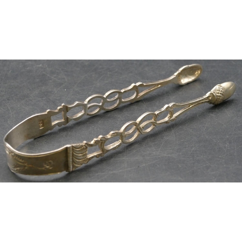 214 - A pair of Georgian silver sugar tongs with acorn shaped bowls with pierced arms