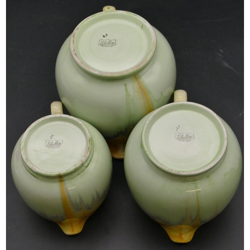 22 - A set of 3 Shelley graduated round bulbous shaped dripware jugs on pale green and yellow ground, lar... 