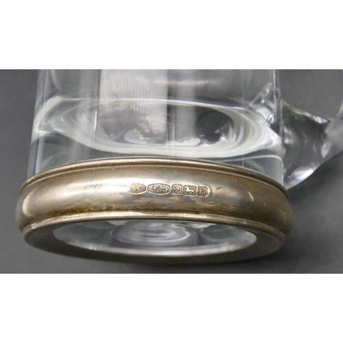 230 - A heavy plain glass tankard with Birmingham silver base, 14cm high