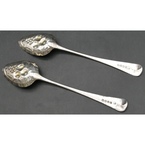 232 - A pair of George III silver berry spoons, embossed bowls with leaf and fruit decoration and engraved... 