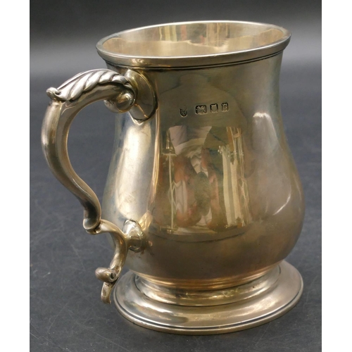 236 - A London silver round bulbous shaped christening mug with scroll handle, engraved inscription on swe... 