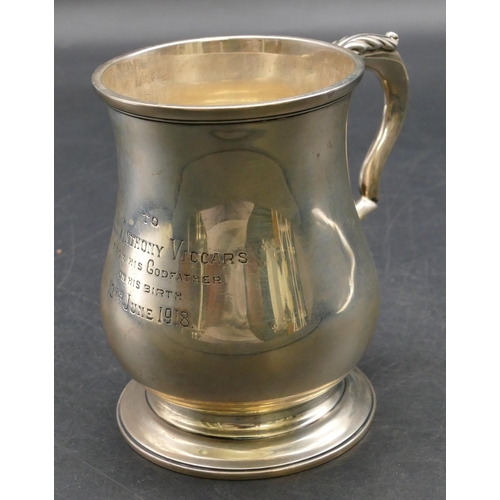 236 - A London silver round bulbous shaped christening mug with scroll handle, engraved inscription on swe... 