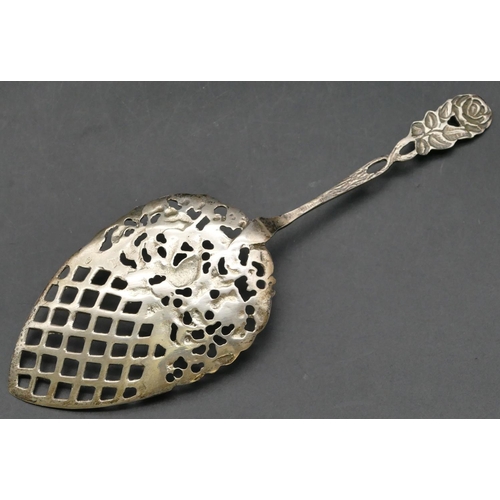 238 - A Dutch silver coloured metal serving spoon with pierced raised bird, floral and scroll decoration, ... 