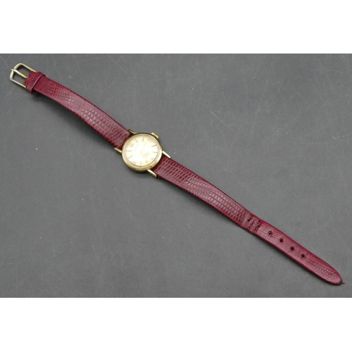 246 - A 9ct gold ladies' Centaur circular wristwatch with red leather strap, approx. 6.3 grams gross witho... 