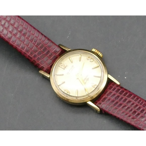 246 - A 9ct gold ladies' Centaur circular wristwatch with red leather strap, approx. 6.3 grams gross witho... 