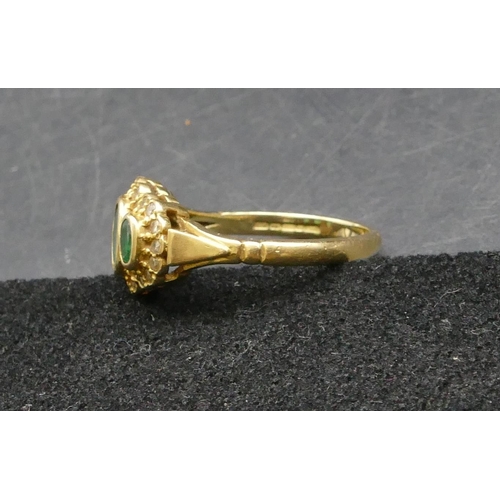 258 - An 18ct gold ladies' ring set with 3 emeralds surrounded by small diamond chips, Size P, 4.9 grams