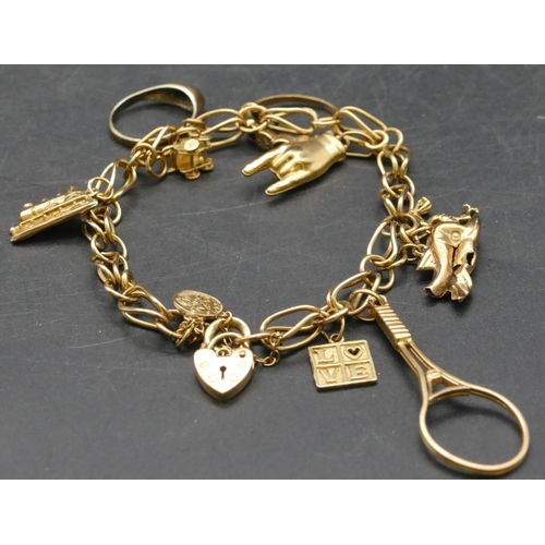 282 - A 9ct gold linked bracelet mounted with 10 gold charms, 20.8 grams gross