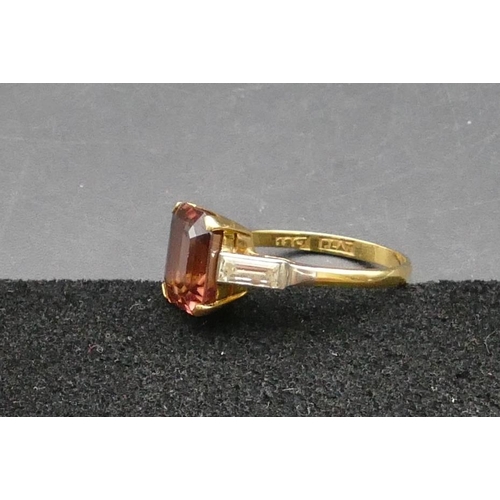 284 - An 18ct gold ladies' ring set with pale garnet and mounted with bagutte diamonds to shoulders, Size ... 