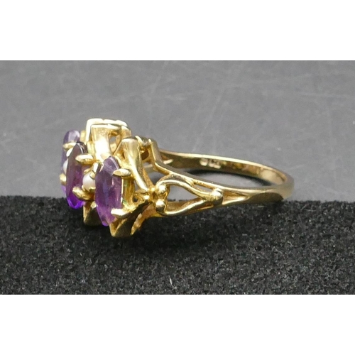 291 - A 9ct gold ladies' cluster ring set with 3 amethysts interspersed by 2 small half pearls, Size Q/R, ... 