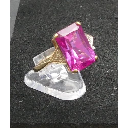 293 - A 9ct gold pink topaz ring flanked by small diamond chips, Size R, 4.4 grams gross