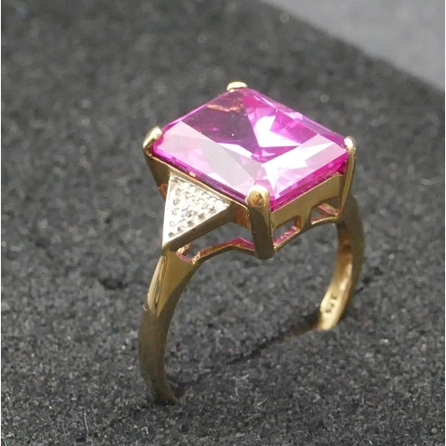 293 - A 9ct gold pink topaz ring flanked by small diamond chips, Size R, 4.4 grams gross